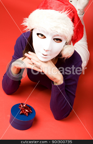 To use this stock image in your creative project, please select the size you need over to the right and click the "Add to Cart" button.
Your downloaded image will come with the Cutcaster watermark removed so don’t worry about the watermark you see on this page. Secret Santa stock photo, A female behind a mask giving a gift by Tyler Olson