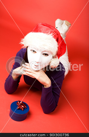 To use this stock image in your creative project, please select the size you need over to the right and click the "Add to Cart" button.
Your downloaded image will come with the Cutcaster watermark removed so don’t worry about the watermark you see on this page. Secret Santa stock photo, A female behind a mask giving a gift by Tyler Olson