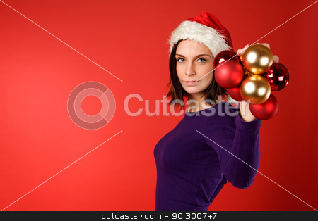 To use this stock image in your creative project, please select the size you need over to the right and click the "Add to Cart" button.
Your downloaded image will come with the Cutcaster watermark removed so don’t worry about the watermark you see on this page. Christmas Decorations stock photo, A young female holding up christmas decorations by Tyler Olson