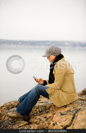 To use this stock image in your creative project, please select the size you need over to the right and click the "Add to Cart" button.
Your downloaded image will come with the Cutcaster watermark removed so don’t worry about the watermark you see on this page. Cellphone by Ocean stock photo, A young woman sitting by the ocean using a cell phone by Tyler Olson