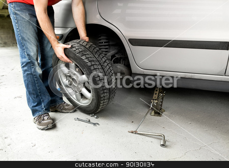 To use this stock image in your creative project, please select the size you need over to the right and click the "Add to Cart" button.
Your downloaded image will come with the Cutcaster watermark removed so don’t worry about the watermark you see on this page. Tire Change stock photo, A male changing a tire on a car in a garage by Tyler Olson