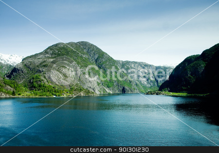 To use this stock image in your creative project, please select the size you need over to the right and click the "Add to Cart" button.
Your downloaded image will come with the Cutcaster watermark removed so don’t worry about the watermark you see on this page. Mountain fjord stock photo, A fjord and rural norway with a blue sky by Tyler Olson