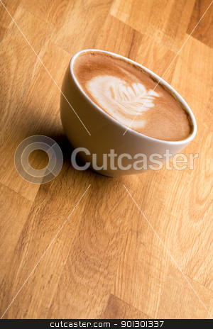 To use this stock image in your creative project, please select the size you need over to the right and click the "Add to Cart" button.
Your downloaded image will come with the Cutcaster watermark removed so don’t worry about the watermark you see on this page. Cafe Latte stock photo, A cappuccino with latte art on a wooden table by Tyler Olson