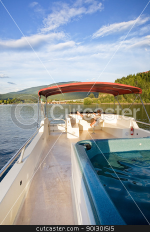 To use this stock image in your creative project, please select the size you need over to the right and click the "Add to Cart" button.
Your downloaded image will come with the Cutcaster watermark removed so don’t worry about the watermark you see on this page. Luxury Boat Owner stock photo, A young male driving a house boat from the upper helm. by Tyler Olson