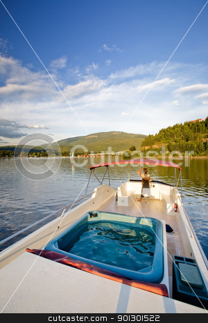 To use this stock image in your creative project, please select the size you need over to the right and click the "Add to Cart" button.
Your downloaded image will come with the Cutcaster watermark removed so don’t worry about the watermark you see on this page. Luxury on a Lake stock photo, A young male at the helm of a luxury boat by Tyler Olson