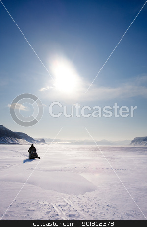 To use this stock image in your creative project, please select the size you need over to the right and click the "Add to Cart" button.
Your downloaded image will come with the Cutcaster watermark removed so don’t worry about the watermark you see on this page. Mountain Winter Landscape stock photo, A snowmobile on frozen ice on a barren winter landscape by Tyler Olson