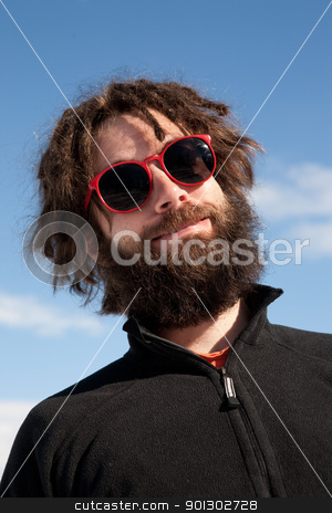 To use this stock image in your creative project, please select the size you need over to the right and click the "Add to Cart" button.
Your downloaded image will come with the Cutcaster watermark removed so don’t worry about the watermark you see on this page. Funny Male Portrait stock photo, A funny portrait of a male with a full beard and sunglasses by Tyler Olson