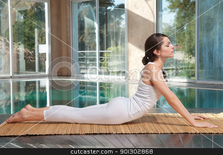To use this stock image in your creative project, please select the size you need over to the right and click the "Add to Cart" button.
Your downloaded image will come with the Cutcaster watermark removed so don’t worry about the watermark you see on this page. Woman doing yoga exercise on mat stock photo, Beautiful young woman practicing yoga on mat by Tyler Olson