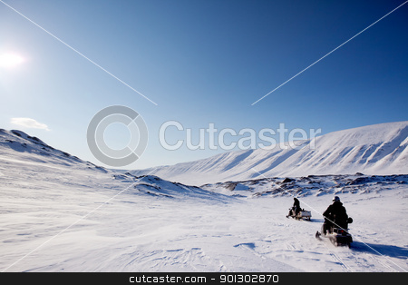 To use this stock image in your creative project, please select the size you need over to the right and click the "Add to Cart" button.
Your downloaded image will come with the Cutcaster watermark removed so don’t worry about the watermark you see on this page. Northern Winter Landsacpe stock photo, Two snowmobiles on a barren winter landscape, Svalbard Norway by Tyler Olson
