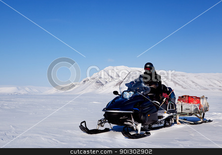 To use this stock image in your creative project, please select the size you need over to the right and click the "Add to Cart" button.
Your downloaded image will come with the Cutcaster watermark removed so don’t worry about the watermark you see on this page. Snowmobile Expedition stock photo, A snowmobile on an arctic expedition on a frozen lake by Tyler Olson