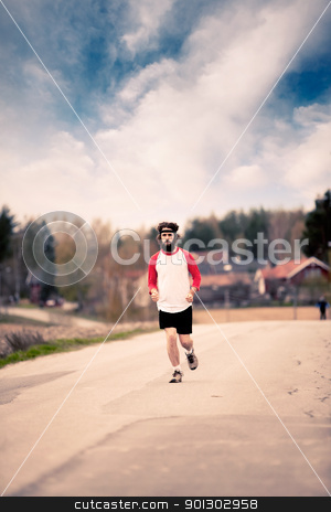 To use this stock image in your creative project, please select the size you need over to the right and click the "Add to Cart" button.
Your downloaded image will come with the Cutcaster watermark removed so don’t worry about the watermark you see on this page. Retro Runner stock photo, A runner with long hair and beard jogging in the country - Retro style image by Tyler Olson