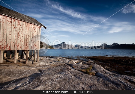 To use this stock image in your creative project, please select the size you need over to the right and click the "Add to Cart" button.
Your downloaded image will come with the Cutcaster watermark removed so don’t worry about the watermark you see on this page. Norway Coast Boat House stock photo, A boat house on the coast of northern Norway by Tyler Olson