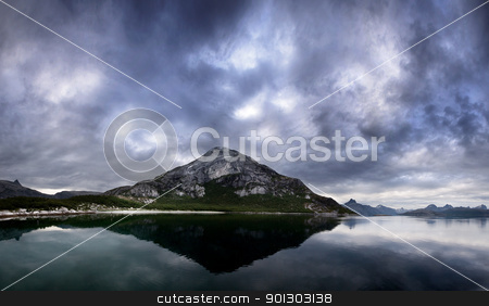 To use this stock image in your creative project, please select the size you need over to the right and click the "Add to Cart" button.
Your downloaded image will come with the Cutcaster watermark removed so don’t worry about the watermark you see on this page. Norway Landscape stock photo, A landscape of a dramatic sky and mountain on the northern coast of Norway by Tyler Olson