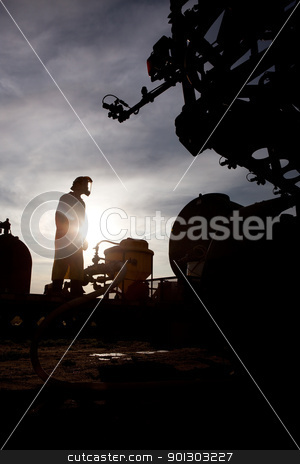 To use this stock image in your creative project, please select the size you need over to the right and click the "Add to Cart" button.
Your downloaded image will come with the Cutcaster watermark removed so don’t worry about the watermark you see on this page. High Clearance Sprayer stock photo, A silhouette of a high clearance sprayer being filled by Tyler Olson