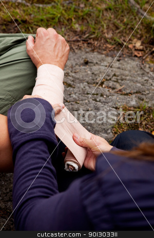 To use this stock image in your creative project, please select the size you need over to the right and click the "Add to Cart" button.
Your downloaded image will come with the Cutcaster watermark removed so don’t worry about the watermark you see on this page. Arm Bandage stock photo, A woman applying an arm bandage on a male camper - focus on male face by Tyler Olson