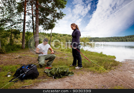 To use this stock image in your creative project, please select the size you need over to the right and click the "Add to Cart" button.
Your downloaded image will come with the Cutcaster watermark removed so don’t worry about the watermark you see on this page. Setting up Tent stock photo, Camping lifestyle - a man and woman setting up a tent by a lake by Tyler Olson