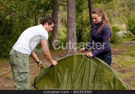 To use this stock image in your creative project, please select the size you need over to the right and click the "Add to Cart" button.
Your downloaded image will come with the Cutcaster watermark removed so don’t worry about the watermark you see on this page. Camping with Tent stock photo, A man and woman setting up a tent in the forest by Tyler Olson