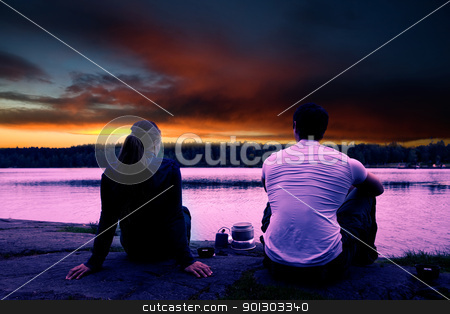 To use this stock image in your creative project, please select the size you need over to the right and click the "Add to Cart" button.
Your downloaded image will come with the Cutcaster watermark removed so don’t worry about the watermark you see on this page. Camping Sunset stock photo, A couple watching the sunset while camping by a lake by Tyler Olson