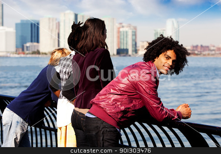 To use this stock image in your creative project, please select the size you need over to the right and click the "Add to Cart" button.
Your downloaded image will come with the Cutcaster watermark removed so don’t worry about the watermark you see on this page. African American stock photo, An African American looking at the camera with a group of friends in the background by Tyler Olson