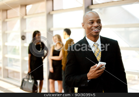 To use this stock image in your creative project, please select the size you need over to the right and click the "Add to Cart" button.
Your downloaded image will come with the Cutcaster watermark removed so don’t worry about the watermark you see on this page. Business Man with Phone stock photo, A business man with a smart phone and co-workers in the background by Tyler Olson