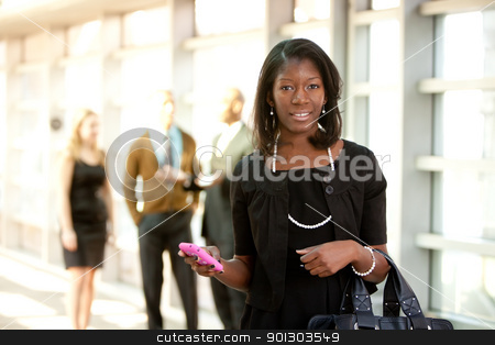 To use this stock image in your creative project, please select the size you need over to the right and click the "Add to Cart" button.
Your downloaded image will come with the Cutcaster watermark removed so don’t worry about the watermark you see on this page. Business Woman with Smart Phone stock photo, A business woman with a smart phone with colleagues in the background by Tyler Olson