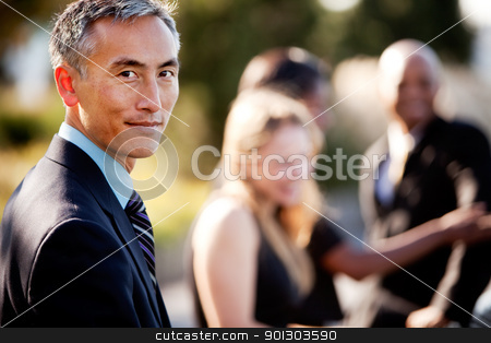 To use this stock image in your creative project, please select the size you need over to the right and click the "Add to Cart" button.
Your downloaded image will come with the Cutcaster watermark removed so don’t worry about the watermark you see on this page. Business Man stock photo, A group of business people outside - sharp focus on Asian man in foreground by Tyler Olson