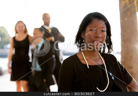 To use this stock image in your creative project, please select the size you need over to the right and click the "Add to Cart" button.
Your downloaded image will come with the Cutcaster watermark removed so don’t worry about the watermark you see on this page. Attractive African American Business Woman stock photo, An attractive African American business woman with colleagues in the background by Tyler Olson