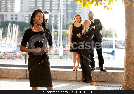 To use this stock image in your creative project, please select the size you need over to the right and click the "Add to Cart" button.
Your downloaded image will come with the Cutcaster watermark removed so don’t worry about the watermark you see on this page. Business Team stock photo, An African American woman in front of a business team by Tyler Olson