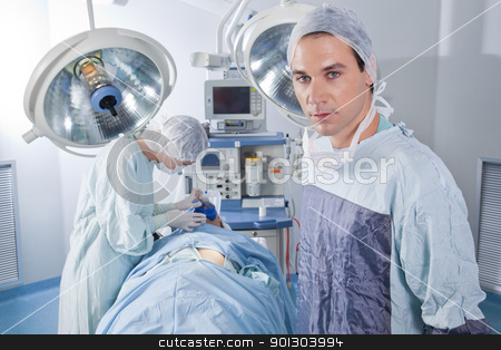 To use this stock image in your creative project, please select the size you need over to the right and click the "Add to Cart" button.
Your downloaded image will come with the Cutcaster watermark removed so don’t worry about the watermark you see on this page. Male doctor confident while surgery stock photo, Confident male doctor in operating room by Tyler Olson