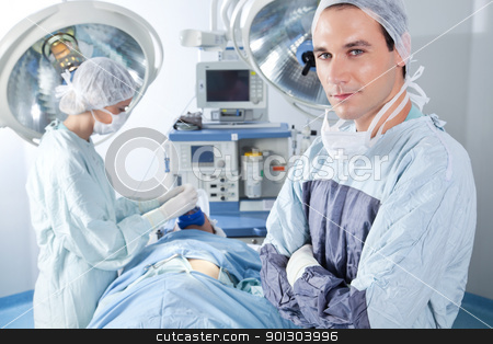 To use this stock image in your creative project, please select the size you need over to the right and click the "Add to Cart" button.
Your downloaded image will come with the Cutcaster watermark removed so don’t worry about the watermark you see on this page. Portrait of male surgeon stock photo, Portrait of male surgeon while nurse applying gas mask to the patient by Tyler Olson