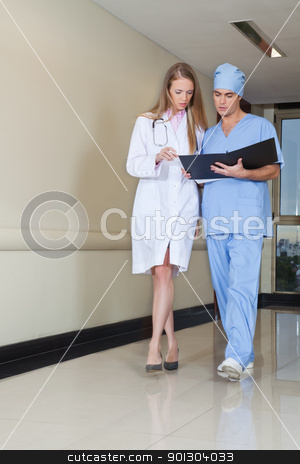 To use this stock image in your creative project, please select the size you need over to the right and click the "Add to Cart" button.
Your downloaded image will come with the Cutcaster watermark removed so don’t worry about the watermark you see on this page. Doctor and nurse with file stock photo, Doctor and nurse reading file while walking in hospital by Tyler Olson