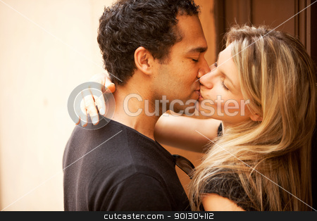 To use this stock image in your creative project, please select the size you need over to the right and click the "Add to Cart" button.
Your downloaded image will come with the Cutcaster watermark removed so don’t worry about the watermark you see on this page. Kiss Outdoor stock photo, A couple kissing outdoors in an European urban setting by Tyler Olson