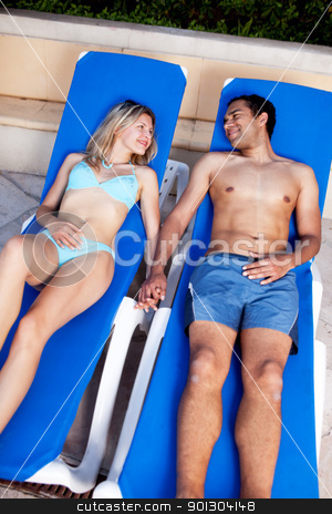 To use this stock image in your creative project, please select the size you need over to the right and click the "Add to Cart" button.
Your downloaded image will come with the Cutcaster watermark removed so don’t worry about the watermark you see on this page. Pool Lounge Chair Couple stock photo, A happy couple lounging in pool chairs by Tyler Olson