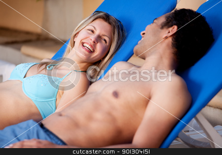 To use this stock image in your creative project, please select the size you need over to the right and click the "Add to Cart" button.
Your downloaded image will come with the Cutcaster watermark removed so don’t worry about the watermark you see on this page. Happy Beach Couple stock photo, A happy couple on pool side chairs having fun by Tyler Olson
