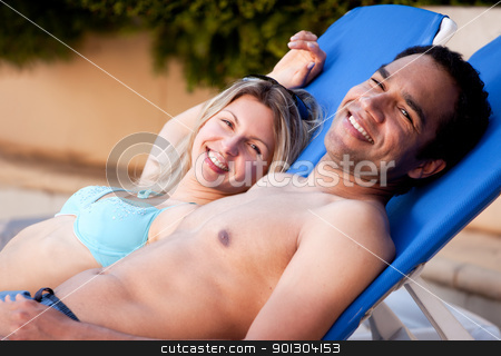 To use this stock image in your creative project, please select the size you need over to the right and click the "Add to Cart" button.
Your downloaded image will come with the Cutcaster watermark removed so don’t worry about the watermark you see on this page. Happy Couple Outdoor Pool stock photo, A happy couple looking at the camera relaxing in pool side chairs by Tyler Olson