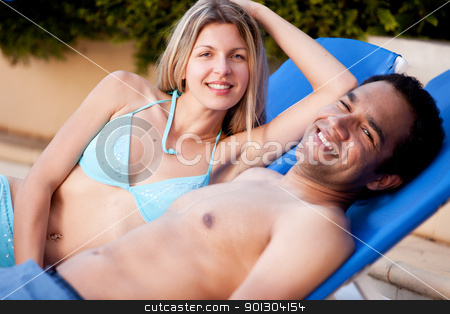 To use this stock image in your creative project, please select the size you need over to the right and click the "Add to Cart" button.
Your downloaded image will come with the Cutcaster watermark removed so don’t worry about the watermark you see on this page. Happy Beach Couple stock photo, A happy couple on beach chairs, looking at the camera by Tyler Olson