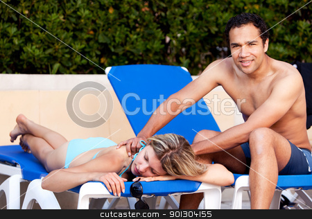 To use this stock image in your creative project, please select the size you need over to the right and click the "Add to Cart" button.
Your downloaded image will come with the Cutcaster watermark removed so don’t worry about the watermark you see on this page. Pool Side Back Massage stock photo, A couple relaxing by the pool, the man giving the woman a back massage by Tyler Olson