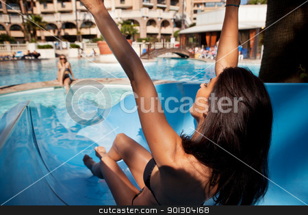To use this stock image in your creative project, please select the size you need over to the right and click the "Add to Cart" button.
Your downloaded image will come with the Cutcaster watermark removed so don’t worry about the watermark you see on this page. Water Slide stock photo, A brunette woman on an outdoor water slide at a hotel by Tyler Olson