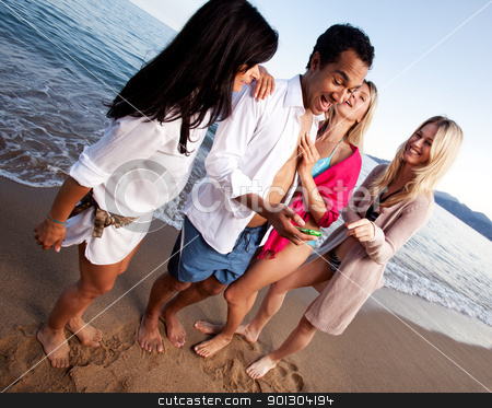 To use this stock image in your creative project, please select the size you need over to the right and click the "Add to Cart" button.
Your downloaded image will come with the Cutcaster watermark removed so don’t worry about the watermark you see on this page. Holiday Friends stock photo, A group of friends having fun at the beach, looking at a cellphone by Tyler Olson