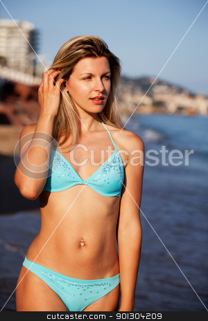 To use this stock image in your creative project, please select the size you need over to the right and click the "Add to Cart" button.
Your downloaded image will come with the Cutcaster watermark removed so don’t worry about the watermark you see on this page. Beach Woman stock photo, A woman walking along the beach with city in the background by Tyler Olson