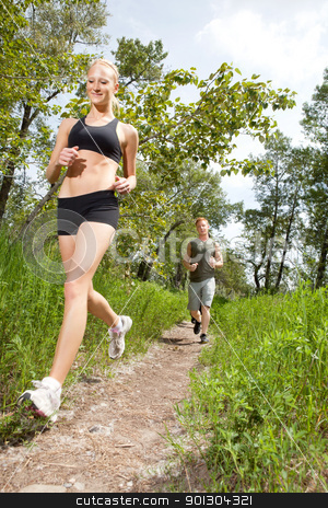 To use this stock image in your creative project, please select the size you need over to the right and click the "Add to Cart" button.
Your downloaded image will come with the Cutcaster watermark removed so don’t worry about the watermark you see on this page. Friends jogging in a forest stock photo, Young man and woman running on a pathway by Tyler Olson