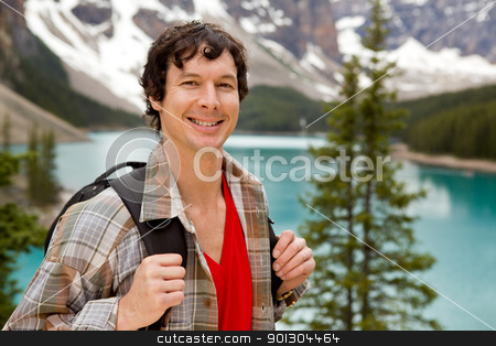 To use this stock image in your creative project, please select the size you need over to the right and click the "Add to Cart" button.
Your downloaded image will come with the Cutcaster watermark removed so don’t worry about the watermark you see on this page. Mountain Hike Portrait stock photo, A portrait of a smiling young male at Lake Moraine, Alberta, Canada by Tyler Olson