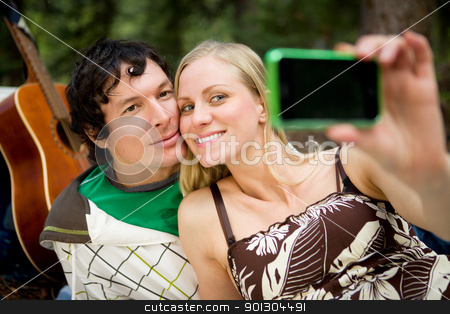 To use this stock image in your creative project, please select the size you need over to the right and click the "Add to Cart" button.
Your downloaded image will come with the Cutcaster watermark removed so don’t worry about the watermark you see on this page. Happy Couple Self Portrait stock photo, A happy couple outdoors taking a self portrait with a camera phone by Tyler Olson