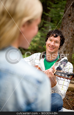 To use this stock image in your creative project, please select the size you need over to the right and click the "Add to Cart" button.
Your downloaded image will come with the Cutcaster watermark removed so don’t worry about the watermark you see on this page. Man Serenading a Woman with Guitar stock photo, A man and woman in a forest with a guitar by Tyler Olson