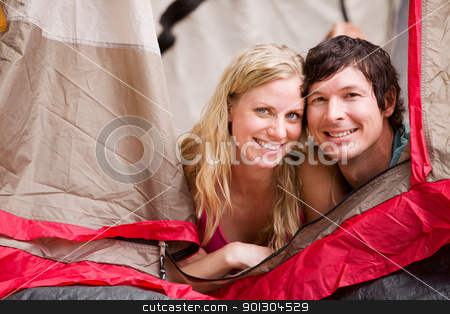 To use this stock image in your creative project, please select the size you need over to the right and click the "Add to Cart" button.
Your downloaded image will come with the Cutcaster watermark removed so don’t worry about the watermark you see on this page. Summer Camping Couple stock photo, A portrait of a couple smiling in a tent by Tyler Olson