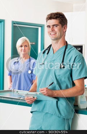 To use this stock image in your creative project, please select the size you need over to the right and click the "Add to Cart" button.
Your downloaded image will come with the Cutcaster watermark removed so don’t worry about the watermark you see on this page. Male veterinarian with clipboard stock photo, Portrait of smiling male veterinarian with clipboard while assistant in the background by Tyler Olson