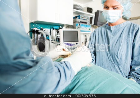 To use this stock image in your creative project, please select the size you need over to the right and click the "Add to Cart" button.
Your downloaded image will come with the Cutcaster watermark removed so don’t worry about the watermark you see on this page. Surgery at Vet Clinic stock photo, A surgeon and assistant work on a small animal at a vet clinic by Tyler Olson