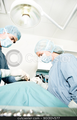 To use this stock image in your creative project, please select the size you need over to the right and click the "Add to Cart" button.
Your downloaded image will come with the Cutcaster watermark removed so don’t worry about the watermark you see on this page. Surgeon Working stock photo, A surgeon working in a small operating room with an assistant by Tyler Olson