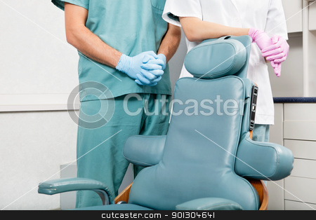 To use this stock image in your creative project, please select the size you need over to the right and click the "Add to Cart" button.
Your downloaded image will come with the Cutcaster watermark removed so don’t worry about the watermark you see on this page. Dentist Detail stock photo, Midsection of a dentist and female assistant in exam room by dentist's chair by Tyler Olson