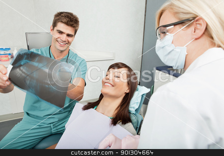 To use this stock image in your creative project, please select the size you need over to the right and click the "Add to Cart" button.
Your downloaded image will come with the Cutcaster watermark removed so don’t worry about the watermark you see on this page. Dental Xray results stock photo, Smiling male dentist explaining the details of x-ray to a beautiful female patient by Tyler Olson